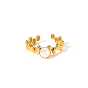 Detail of vintage 18K gold plated titanium ring with beaded wave design and white pearl