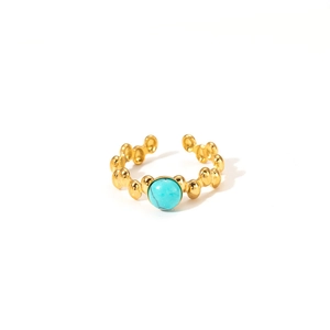 Detail of adjustable 18K gold titanium ring with turquoise center and metal beads