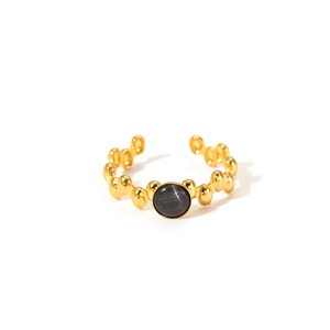 Detail of vintage 18K gold plated ring featuring beaded texture and grey cat eye stone