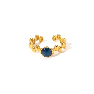 Detail of vintage 18K gold plated ring featuring textured dots and oval blue stone