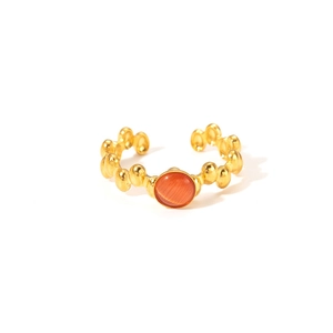 Detailed macro of vintage 18K gold plated ring with orange stone and beaded band