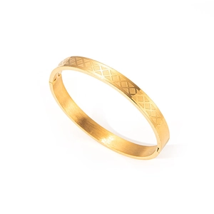 Primer plano de pulsera de acero inoxidable dorado con grabado geométrico de diamantes