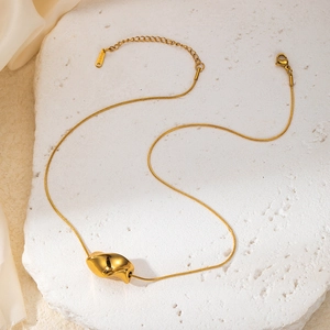 Detail of twisted gold pendant on fine snake chain with S.STEEL hallmark engraving