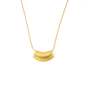 Detail of gold-plated pendant with hammered texture and fine snake chain for women