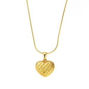 Detail of a textured 18K gold heart pendant with a sleek snake chain necklace