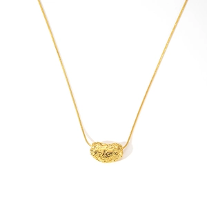 Detailed view of golden heart pendant with embossed floral patterns on a gold chain