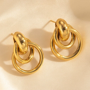 Detail of 18k gold plated stainless steel nested double hoop earrings on silk