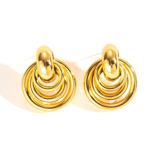 Detail of vintage intertwined concentric hoop earrings with polished 18k gold plated finish