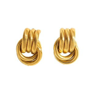 Macro detail of vintage gold-plated hoop earrings with textured spiral knot design