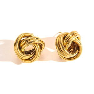 Macro shot of gold intertwined rope knot stud earrings with polished vintage texture