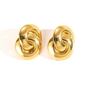 Detail of interlocking chunky gold hoop earrings with a polished metallic finish