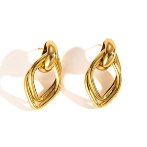 Detail view of interlocking golden geometric hollow diamond rings and polished ear cuff