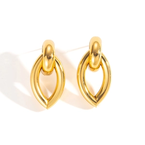 Detailed macro view of gold-plated geometric interlocking hoop earrings in high-polish finish