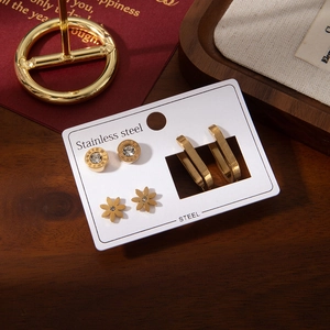 Three-pair gold titanium steel earring set with Roman numerals, flowers, and geometric hoops
