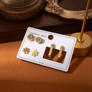 Titanium steel earring set featuring gold Roman flower studs and hoops for women