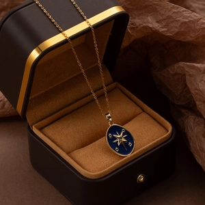 Luxury gold starburst necklace with blue enamel pendant and premium gift box