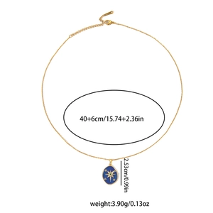 Detailed view of gold starburst necklace with blue oval pendant and size measurements