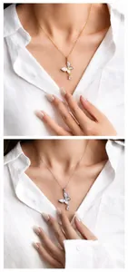 Detail of luxury butterfly necklace with water drop zircon on model wearing white shirt