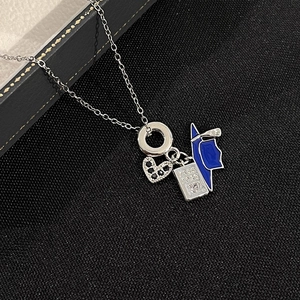 Titanium steel necklace featuring heart zircon and passport book charm on black fabric
