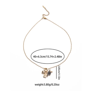 Detail of gold titanium heart and passport pendant necklace with adjustable chain links