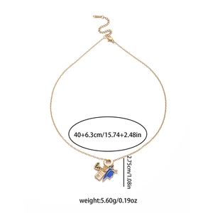 Gold graduation necklace with heart, passport, and blue doctoral cap charms on white background