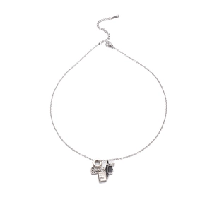 Macro detail of S925 silver necklace with black heart and GOOD LUCK square charms
