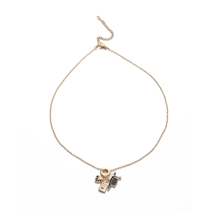 Detailed shot of golden necklace with heart zircon and passport book charm pendants