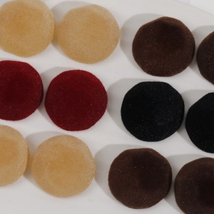 Macro shot of circular flocked DIY jewelry accessories in dark tones and velvet texture