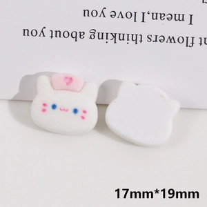 Macro view of 17x19mm flocked white puppy resin charms with pink nurse hat for DIY crafts