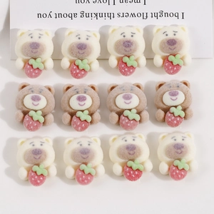 Close-up of 12 flocked teddy bear charms with strawberries for DIY hair clips
