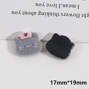 Detail showing front and back of 19mm grey cat resin patch with flocking texture