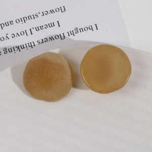 Detail of plush flocked resin charm and warm brown earring component for DIY jewelry