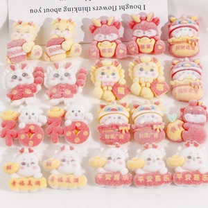 Flat lay of red resin dragon charms for DIY accessories with Chinese New Year greetings
