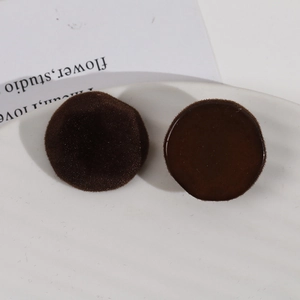 Detailed comparison of brown round resin charms with velvet flocking and glossy finishes