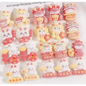 Macro shot of 2024 Chinese New Year resin charms with dragon and fortune themes