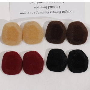 Flat lay of oval flocked jewelry patches in burgundy and brown for DIY accessories