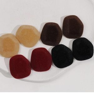 Velvet geometric hair clip accessories in wine red and neutral tones on a white tray