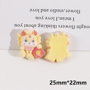 Macro view of cartoon yellow dragon resin charm with red lucky bag for DIY jewelry