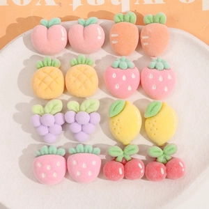 Macro view of 16-piece set of flocked fruit and vegetable resin charms for DIY hair clips