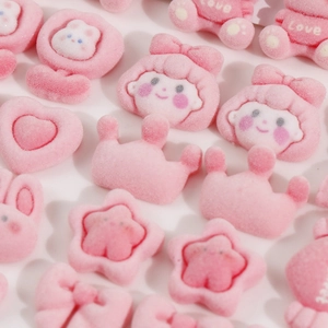 Detailed view of pink flocked DIY charms featuring teddy bears hearts and stars