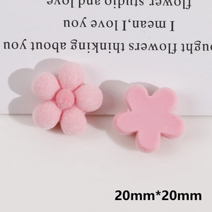 Detail of 20mm light pink flower DIY charms in flocked and smooth resin finishes