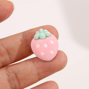 Close-up of a pink flocked strawberry resin charm for DIY hair clips and jewelry