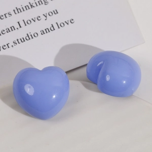 Detailed macro view of glossy lavender heart resin studs with smooth polished finish