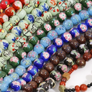 Macro shot of 12mm hand-painted ceramic beads with colorful floral patterns for DIY jewelry