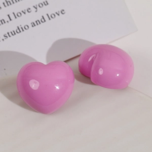 Close-up of shiny lavender resin heart-shaped DIY craft parts for jewelry making