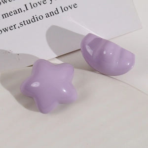 Detail of glossy lilac star and semicircle resin cabochons for DIY hair accessories