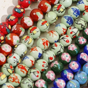 Macro shot of 12mm hand-painted ceramic beads with floral patterns for DIY jewelry