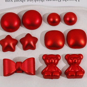 Detailed view of red bow star bear acrylic charms for DIY hair clip and jewelry making
