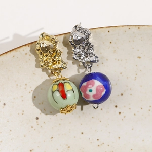 Artisan asymmetric ceramic earrings with hand-painted patterns and lava metal texture