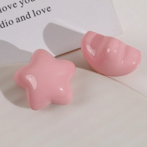 Close-up of pink glossy resin star and shell-shaped DIY hair accessory materials